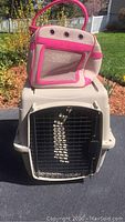 Dog crate with canvas pet carrier placed on top, showing both items and their relative size