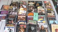 Overview of approximately 30 mixed music CDs including several by Claflin Hill Symphony Orchestra and Holiday Pops collections