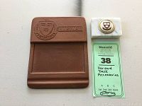 Pair of Harvard desk accessories together, one leather and one marble, with a tag showing lot number and title.
