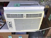 Frigidaire 5000 BTU window air conditioner showing front and side views with vent and control panel.