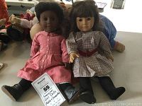 Front view of Addie and Samantha dolls seated