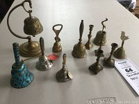 Photo showing the full set of 8 bells and 4 candlesticks arranged on table