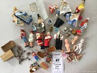 Overview of entire miniature dolls and mice lot, showing dolls, mice, small baskets and other figures