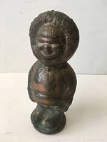 Front view of the metal Eskimo figure showing detailed hood and face.