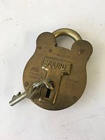 Vintage brass Squire padlock front showing branding and features