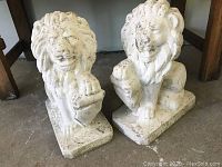 Front view of both statues showing seating position and rectangular bases