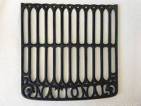 Top view of square metal grate showing vertical elongated slots with 'NATIONAL' embossing at bottom edge and decorative scroll corners.