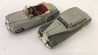 Photo showing the Bentley S2 and Rolls Royce Silver Wraith diecast model cars side by side from an angled top-front perspective