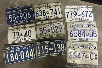 Shows nine pairs of vintage licence plates from Ontario and British Columbia dating from 1965, 1967, 1970, 1971, 1972 and 1999. Plates vary in color from blue with white text to white with blue or black text.