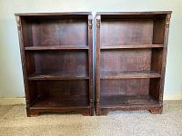 Front view of the two matching walnut antique bookcases showing overall structure and trim details.