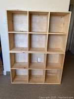 Front view of one pine bookcase showing 6 cubby compartments in a 3x2 arrangement