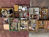 Overview of many boxes filled with mixed vintage costume jewelry and beads, showing various necklaces, bracelets, and pins.