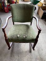 Front view showing chair seat with visible upholstery tears and floral pattern fabric.