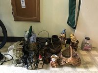 Full view of plant holders, gnomes, pitcher, deer sculptures, basket and electric garden fountain grouped on floor