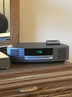 Front view of Bose Wave system showing digital display, CD slot and iPod dock cradle on top