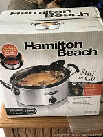 Photo of boxed Hamilton Beach slow cooker crock pot showing brand, model, and features.