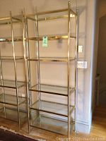 Front view of the chrome and glass etagere showing five glass shelves inside a rectangular chrome frame