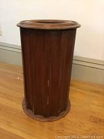 Full view of cylindrical vintage column side table with wood veneer and circular marble inset top