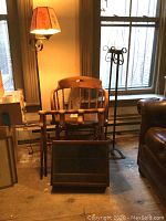 Overview of all items grouped showing chair, luggage rack, display case, candle stands, and lamp near window