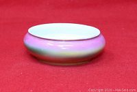 Side view of pink and white oval pin dish showing gradient color and smooth shape