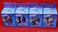 Four M&M's Groovy radios in original packaging showing front view of boxes with colorful branding.