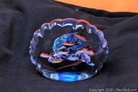 Front view of vintage Murano-style art glass fish paperweight with colorful fish inside a clear glass aquarium shape and scalloped top edge.