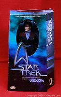 Front view of factory sealed Star Trek Voyager Captain Kathryn Janeway 12-inch action figure in original box with The Women of Star Trek branding visible.