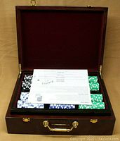Poker chip set with 500 assorted printed chips and poker guide inside high gloss wood case with velvet lining.