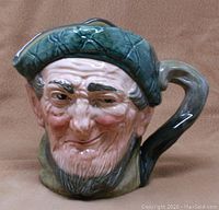 Front view of Royal Doulton Toby Mug/Pitcher showing detailed facial features of ‘Auld Mac’ character and handle.
