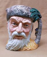Front view of Royal Doulton Toby Jug featuring detailed facial characterization of Robinson Crusoe with white beard and textured hat and handle.