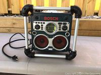 Front view of BOSCH power box showing speaker cones, control panel, BOSCH branding, and pipe frame.