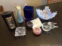 Overview of entire lot showing all items on dark wood table.