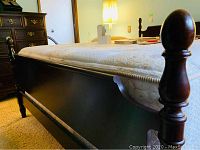 Side view of bed footboard and metal side rail