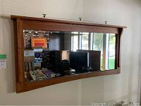 Front view of oak framed mirror with top shelf
