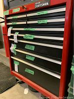 Red Sears Craftsman rolling tool cart showing labels on drawers