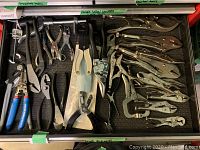 Full drawer view showing assortment of locking pliers, tin snips, wire stripper and other pliers
