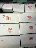 Nine Sherline Products white cardboard boxes with red Sherline logos showing various P/N labels including 1010, 1074, 1270, 3051