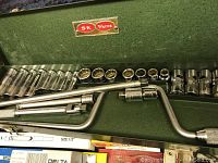 Open green S-K Wayne case showing chrome deep and shallow 1/2" drive sockets, two T-handles and a universal joint