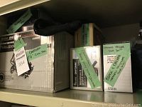 Photo showing original boxed items with green labels identifying Craftsman circular saw, disc grinder, rotary grinder, Black and Decker glue gun, and propane torch kit.