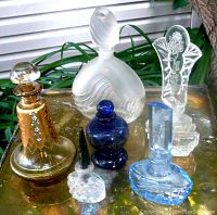 Photo showing six decorative art glass perfume bottles with diverse designs, sizes range from 3.5" to 9.5".