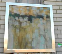 Front view of the abstract canvas art showing the color palette and texture within the silver metal frame.