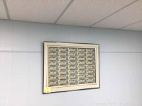 Full view of framed uncut sheet hanging on wall