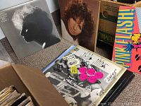 Photo showing Barbara Streisand record cover with black and white profile silhouette, adjacent to other records including Pink Flash graphic.