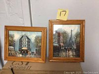 Two framed oil paintings on canvas, cityscape scenes by Marry Botto with oak frames.