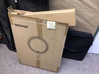 Cardboard box with Neewer branding containing the ring LED light, showing front with logo and image of ring light.