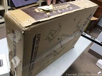 Sealed cardboard box labeled GT Omega Racing and APEX Steering Wheel Stand