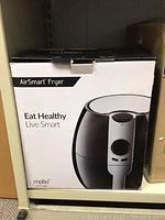 Front box view of the Molla AirSmart Fryer showing the product image and slogan 'Eat Healthy Live Smart'