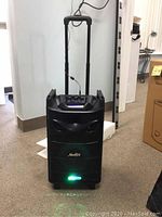 Photo of Moukey MTS101 trolley speaker upright with LED light on and extended handle