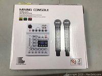 Top view of sealed product box showing mixing console and two wireless microphones pictured on front with product name and logo.