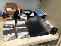 Overview of lot with packed pulse oximeters, Apple Watch armor cases, and various accessories visible on shelf.